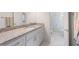 Bathroom features a vanity with granite countertops and a mirror at 5138 Price Dr, Suwanee, GA 30024