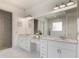 Bright bathroom with granite countertops, double sinks, a large mirror, and a walk-in shower at 5138 Price Dr, Suwanee, GA 30024