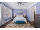 Spacious bedroom with a stylish ceiling fan, soft lighting, and a cozy seating area at 5138 Price Dr, Suwanee, GA 30024