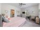 Bright bedroom includes a ceiling fan, window, desk, and comfortable bed at 5138 Price Dr, Suwanee, GA 30024
