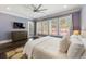 Sunlit bedroom with large windows, hardwood flooring, and a view to the backyard at 5138 Price Dr, Suwanee, GA 30024