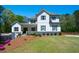 Stunning two-story home with modern farmhouse charm and well-manicured lawn at 5138 Price Dr, Suwanee, GA 30024