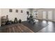 Home gym featuring exercise equipment, hardwood flooring, and natural light at 5138 Price Dr, Suwanee, GA 30024