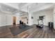 Spacious home gym features wood floors, recessed lights, exercise equipment, and a mounted television at 5138 Price Dr, Suwanee, GA 30024