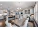 Open kitchen with stainless steel appliances, kitchen island and bar with a view into the dining and living areas at 5138 Price Dr, Suwanee, GA 30024