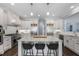 Spacious kitchen with white cabinets, stainless steel appliances, and a granite island with seating at 5138 Price Dr, Suwanee, GA 30024