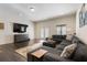 Spacious living room area with a large sectional sofa, television, and flooring at 5138 Price Dr, Suwanee, GA 30024