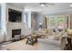 Cozy living room with a brick fireplace, built-in shelving, and sliding glass doors at 5138 Price Dr, Suwanee, GA 30024