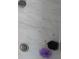 Modern shower with marble tile, rainfall showerhead, and stylishly textured washcloths at 5138 Price Dr, Suwanee, GA 30024