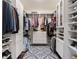 Spacious walk-in closet featuring custom shelving and a patterned rug at 5138 Price Dr, Suwanee, GA 30024