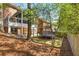 View of the backyard with a trampoline, porch, and steps leading up to the home at 1020 Burton Ne Dr, Atlanta, GA 30329