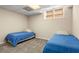 Finished basement featuring neutral paint, a decorative ceiling, carpet, and twin beds at 1020 Burton Ne Dr, Atlanta, GA 30329