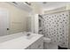 Full bathroom with white vanity, mirror, and shower with polka dot curtain at 1020 Burton Ne Dr, Atlanta, GA 30329