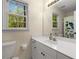 Bright bathroom featuring a large mirror, white vanity, and a shower with a butterfly curtain at 1020 Burton Ne Dr, Atlanta, GA 30329