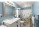 Blue-painted bathroom featuring a decorative ceiling, vanity, toilet, and shower with a floral curtain at 1020 Burton Ne Dr, Atlanta, GA 30329