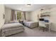 Neutral bedroom featuring two twin beds, a desk, shelving, and a window with natural light at 1020 Burton Ne Dr, Atlanta, GA 30329