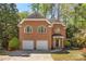 Charming two-story brick home featuring a two-car garage and well-manicured landscaping at 1020 Burton Ne Dr, Atlanta, GA 30329