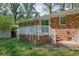 View of the back patio of the brick home with white banister and stairs at 1093 Lanier Sw Dr, Marietta, GA 30060