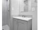 Bathroom with tiled walk-in shower, gray vanity, and white countertop at 1093 Lanier Sw Dr, Marietta, GA 30060
