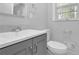 Bright bathroom with gray vanity, white countertop, and a nearby toilet at 1093 Lanier Sw Dr, Marietta, GA 30060