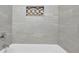 Elegant bathroom features white tiles, a decorative tile inset, and chrome fixtures at 1093 Lanier Sw Dr, Marietta, GA 30060
