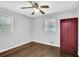 This cozy bedroom features hardwood floors, a ceiling fan, two windows and a built-in closet at 1093 Lanier Sw Dr, Marietta, GA 30060