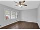 Bright bedroom features hardwood floors, ceiling fan, and windows overlooking the front yard at 1093 Lanier Sw Dr, Marietta, GA 30060