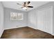 Bedroom with ceiling fan, hardwood floors, closet, and bright natural light from two windows at 1093 Lanier Sw Dr, Marietta, GA 30060