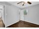 Bedroom with ceiling fan, hardwood floors, and bright natural light from window at 1093 Lanier Sw Dr, Marietta, GA 30060