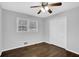 Bedroom with ceiling fan, hardwood floors, closet, and bright natural light from two windows at 1093 Lanier Sw Dr, Marietta, GA 30060
