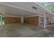 Carport of the brick home with concrete floor and white supports at 1093 Lanier Sw Dr, Marietta, GA 30060