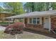 Close up of brick ranch style home with beautiful landscaping and a covered carport at 1093 Lanier Sw Dr, Marietta, GA 30060