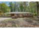 Well-maintained single-story brick home with a carport and mature trees at 1093 Lanier Sw Dr, Marietta, GA 30060