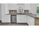 Updated kitchen with white cabinets, stainless steel dishwasher and granite countertops at 1093 Lanier Sw Dr, Marietta, GA 30060