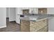 Stylish kitchen with granite countertops, brick-accented peninsula, and stainless steel dishwasher at 1093 Lanier Sw Dr, Marietta, GA 30060