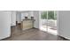 Open kitchen featuring white cabinets, granite counters, and sliding glass door to deck at 1093 Lanier Sw Dr, Marietta, GA 30060