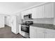Bright kitchen featuring stainless steel appliances, granite countertops, and white cabinetry at 1093 Lanier Sw Dr, Marietta, GA 30060