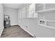 Clean laundry room with grey flooring, white walls and trim, shelving, and closet rack at 1093 Lanier Sw Dr, Marietta, GA 30060
