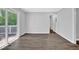 Living room features hardwood floors, grey walls, and glass sliding doors to outdoor balcony at 1093 Lanier Sw Dr, Marietta, GA 30060