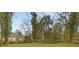 Large backyard with mature trees and lush lawn provides privacy and space for outdoor activities at 2166 Belvedere Sw Ave, Atlanta, GA 30311