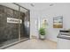 Modern bathroom features a glass shower with black marble tile, double sink vanity, and neutral decor at 2166 Belvedere Sw Ave, Atlanta, GA 30311