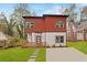 Modern two-story home boasts a red and white exterior, inviting front porch, and well-manicured lawn at 2166 Belvedere Sw Ave, Atlanta, GA 30311