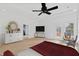 Bright bedroom features a tray ceiling, modern fan, large windows, and neutral decor. Door leading to back porch at 2166 Belvedere Sw Ave, Atlanta, GA 30311
