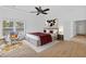Bright main bedroom features a tray ceiling, modern fan, and neutral decor with large windows at 2166 Belvedere Sw Ave, Atlanta, GA 30311