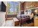 Comfortable bedroom featuring exposed brick walls, large windows, and stylish decor at 978 North Ne Ave # 207, Atlanta, GA 30306