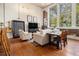 Bright living room featuring hardwood floors, tall windows, exposed brick and stylish decor at 978 North Ne Ave # 207, Atlanta, GA 30306