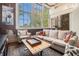 Cozy living area with exposed brick wall, large windows, and stylish furnishings at 978 North Ne Ave # 207, Atlanta, GA 30306