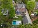 Aerial view showcasing a home's backyard with a pool, trampoline, firepit, deck, and mature landscaping at 1116 Dan Johnson Ne Rd, Atlanta, GA 30307