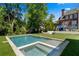 Swimming pool and hot tub in a landscaped backyard with an outdoor lounge area and manicured lawn at 1116 Dan Johnson Ne Rd, Atlanta, GA 30307