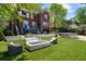 This backyard has artificial turf, a trampoline, a deck with a slide, and an outdoor fireplace at 1116 Dan Johnson Ne Rd, Atlanta, GA 30307